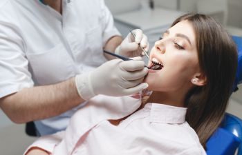 Woman in a dental chair during a teeth exam.